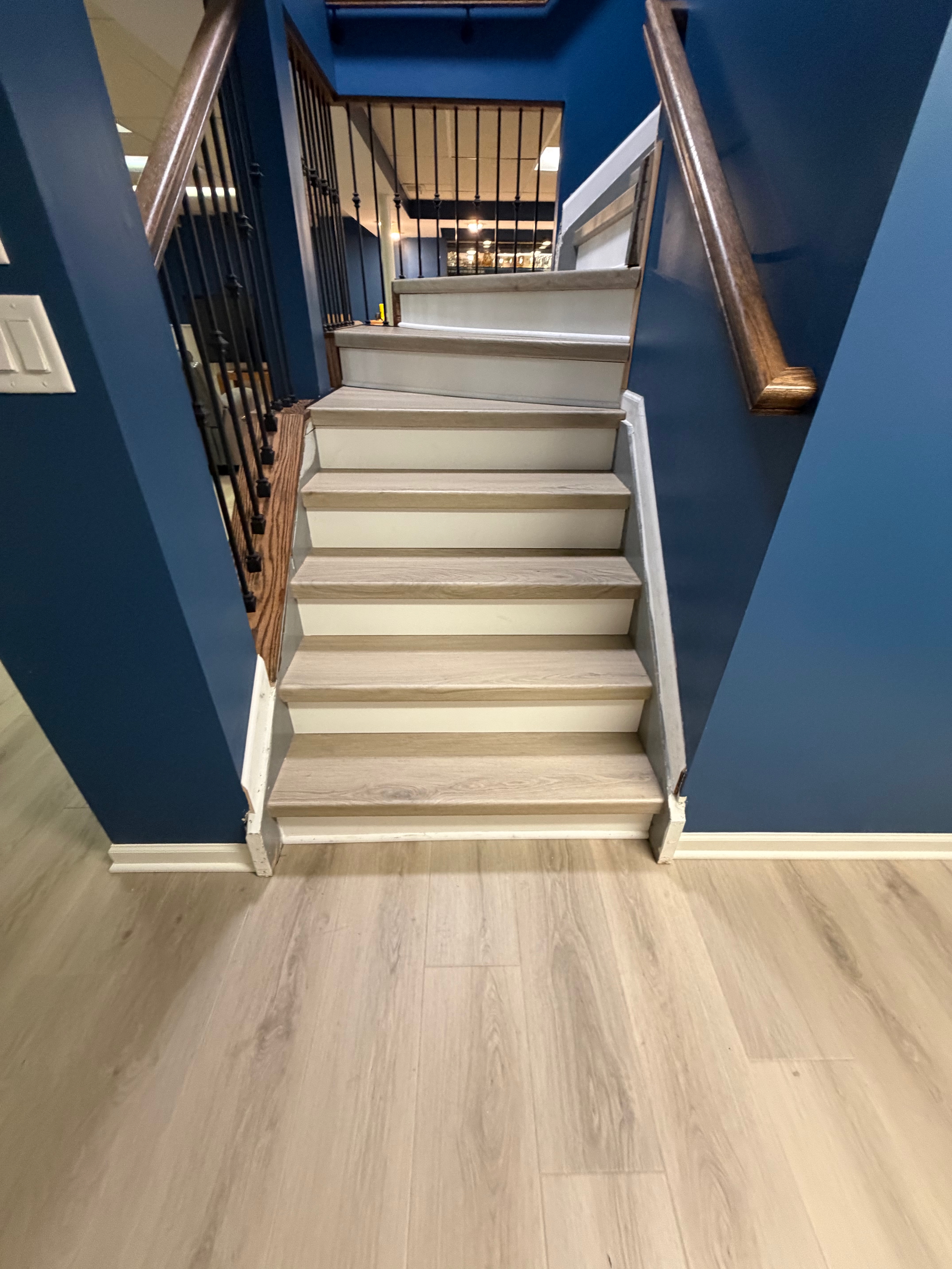 Greige SPC vinyl stair treads with white risers on a finished staircase